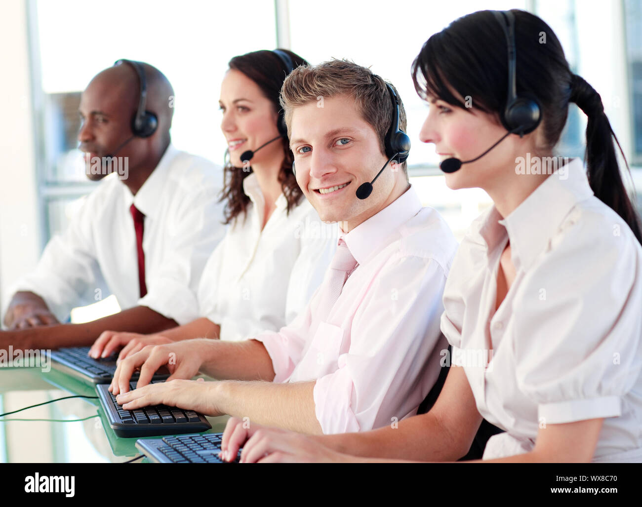 Business called centre with people on headsets Stock Photo