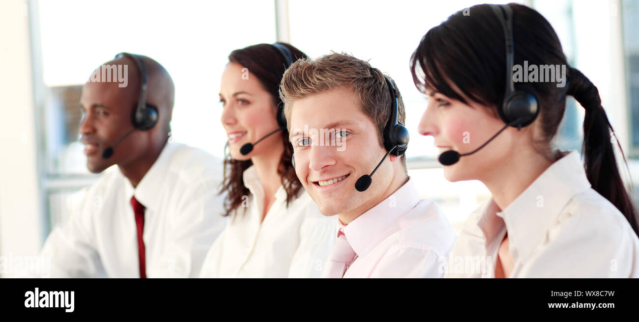 Business called centre with people on headsets Stock Photo