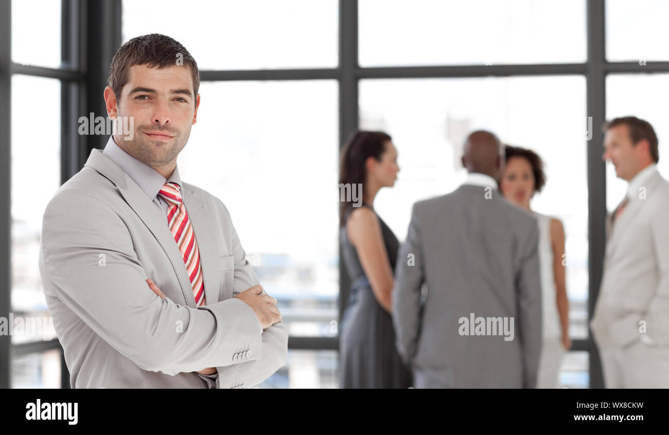 Enthousiastic businessman being Positive with team in Background Stock Photo
