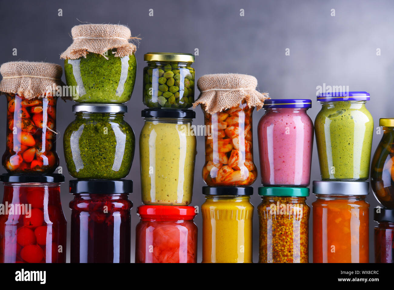 Jars with variety of pickled vegetables and fruits. Preserved food