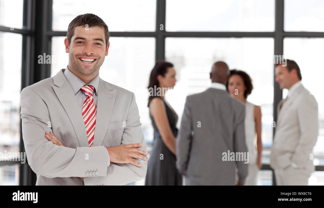 Cute businessman being Positive with team in Background Stock Photo