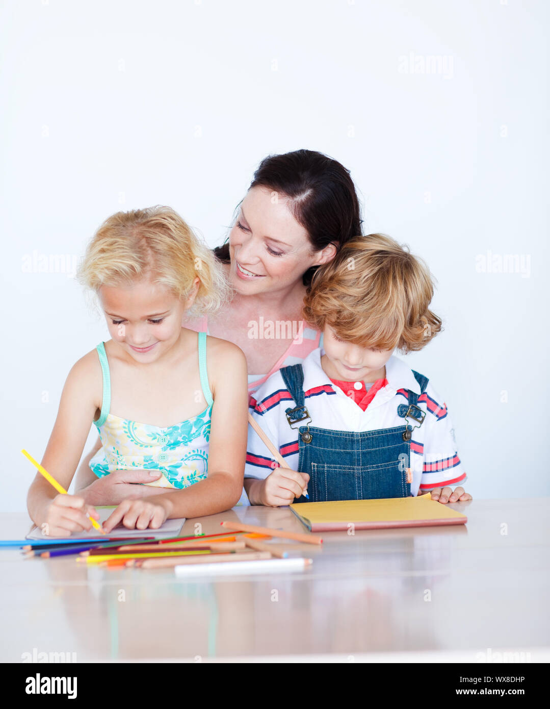 Mother painting with her children at home Stock Photo - Alamy