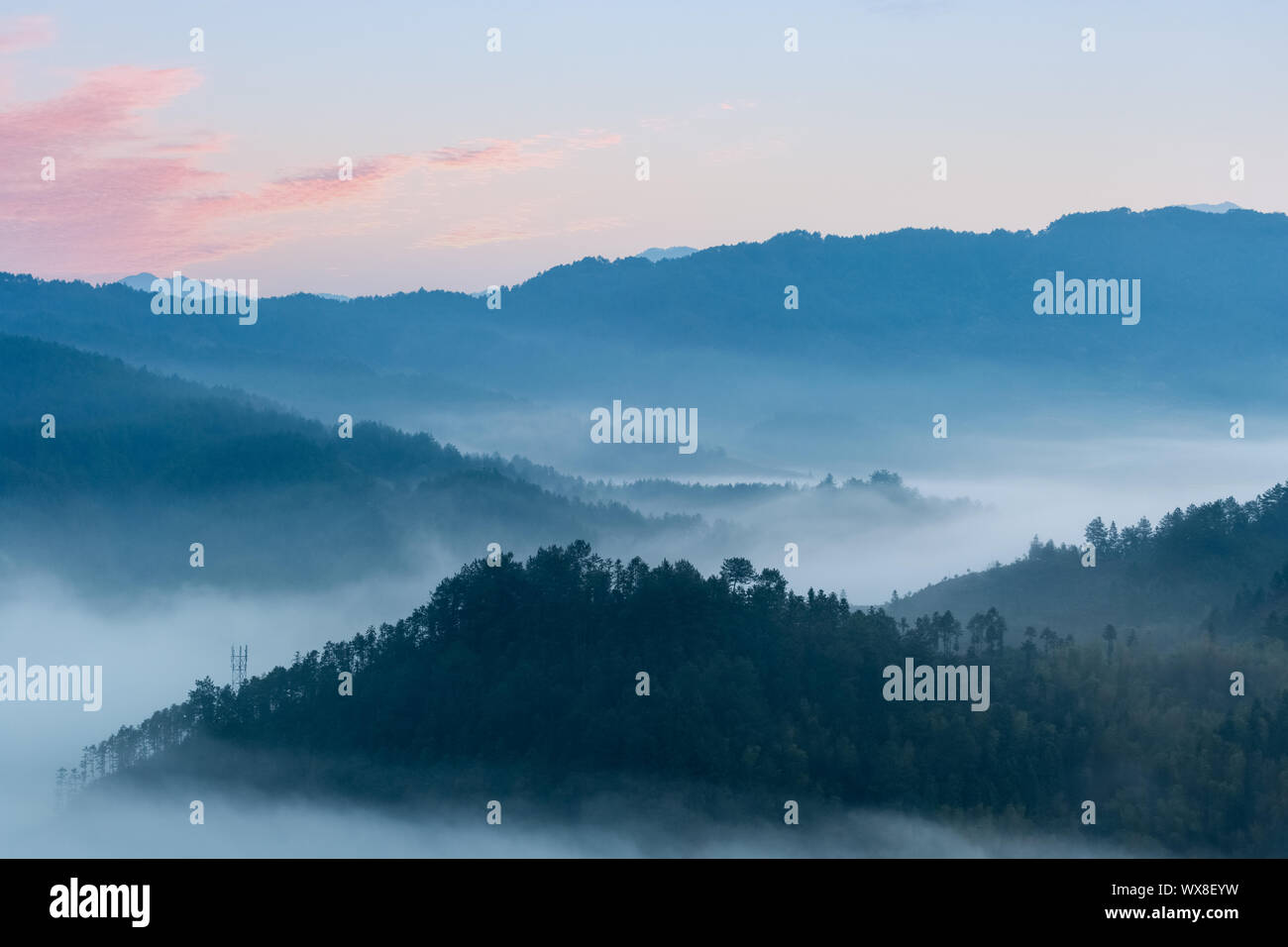 rosy clouds and misty blue mountains Stock Photo