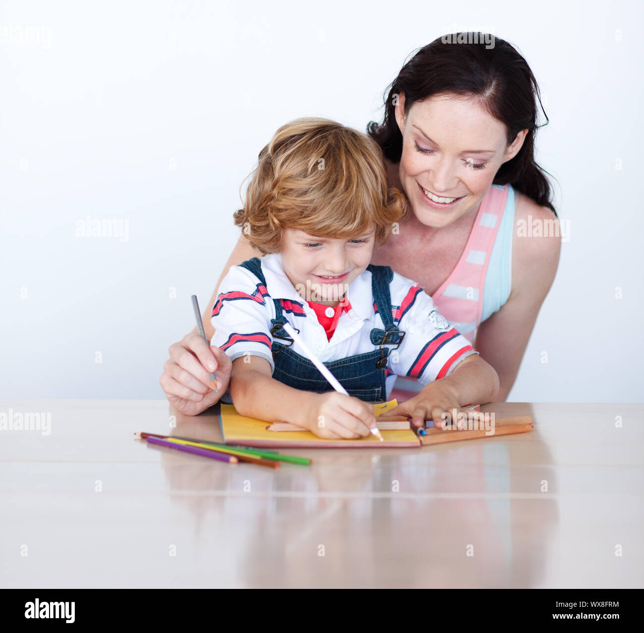 Mother and son doing homework together at home Stock Photo - Alamy