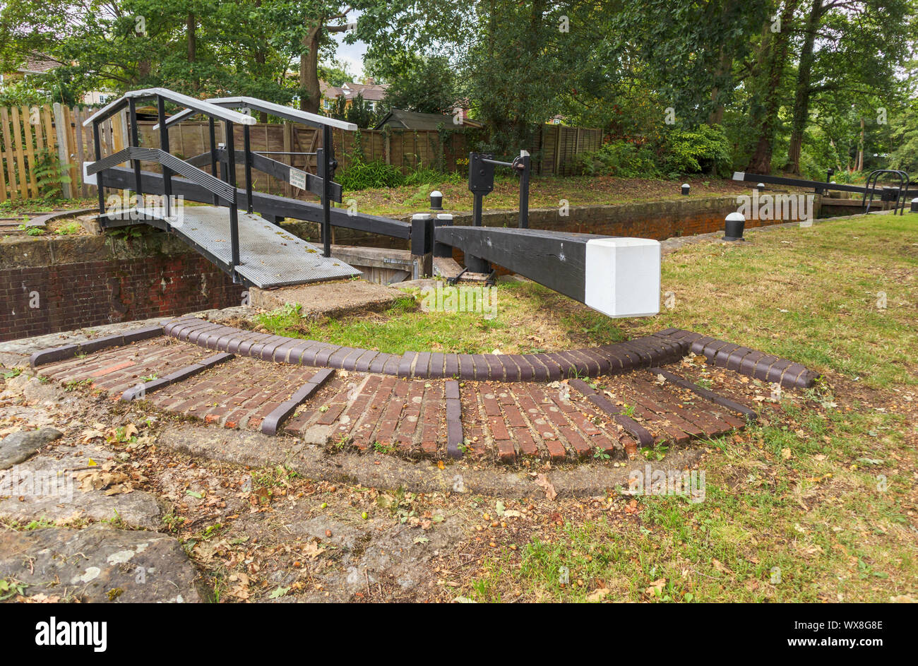 Typical pound lock on the Basingstoke Canal and towpath, Knaphill, Woking, Surrey, southeast England, UK Stock Photo