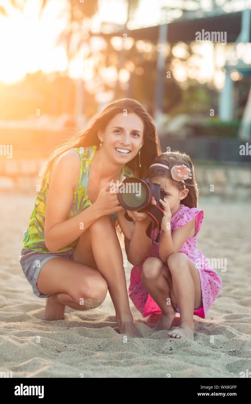 Mother and daughter taking photos with camera Stock Photo
