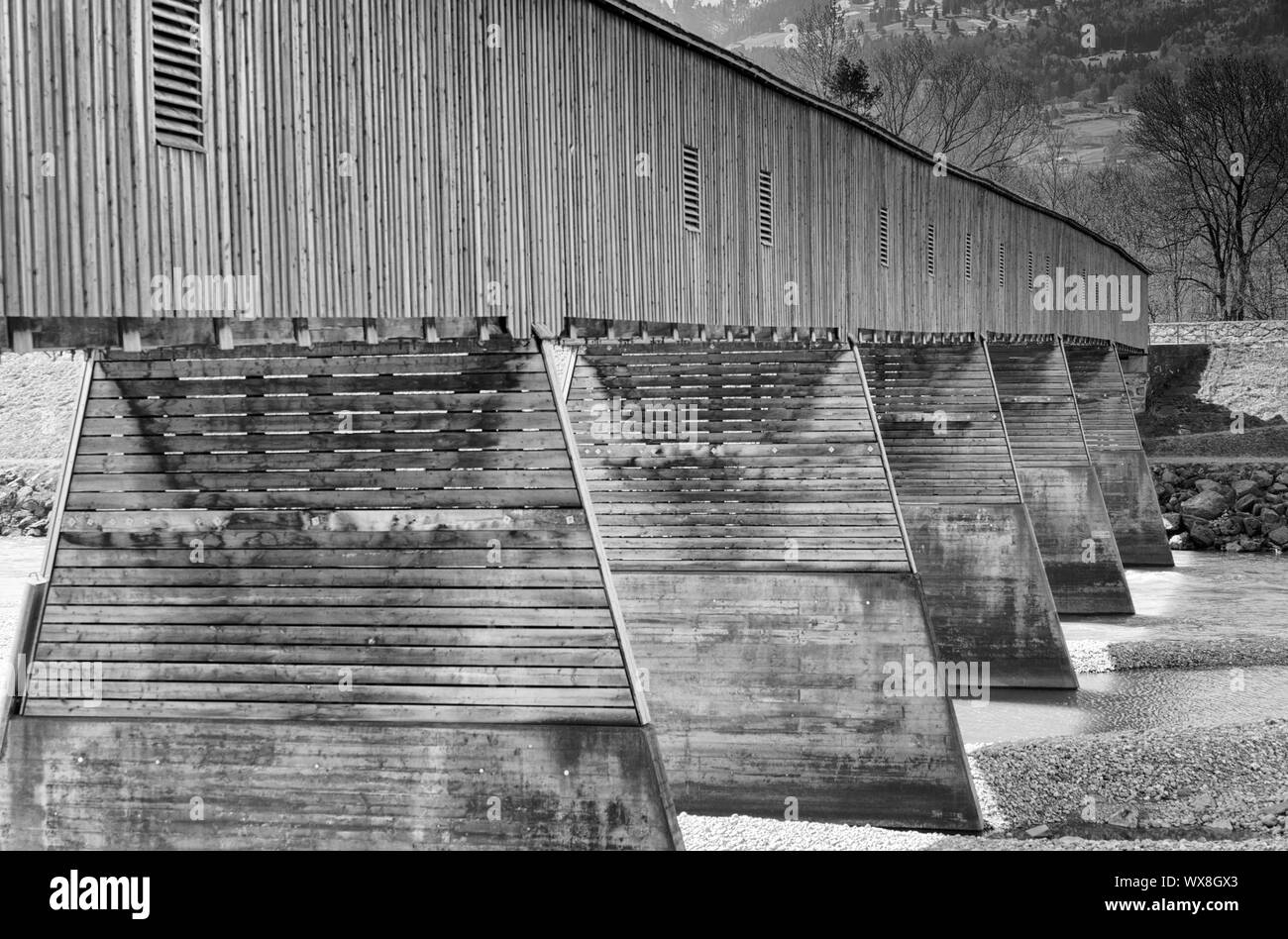 historic wooden covered bridge across the Rhine between Switzerland and Liechtenstein Stock Photo