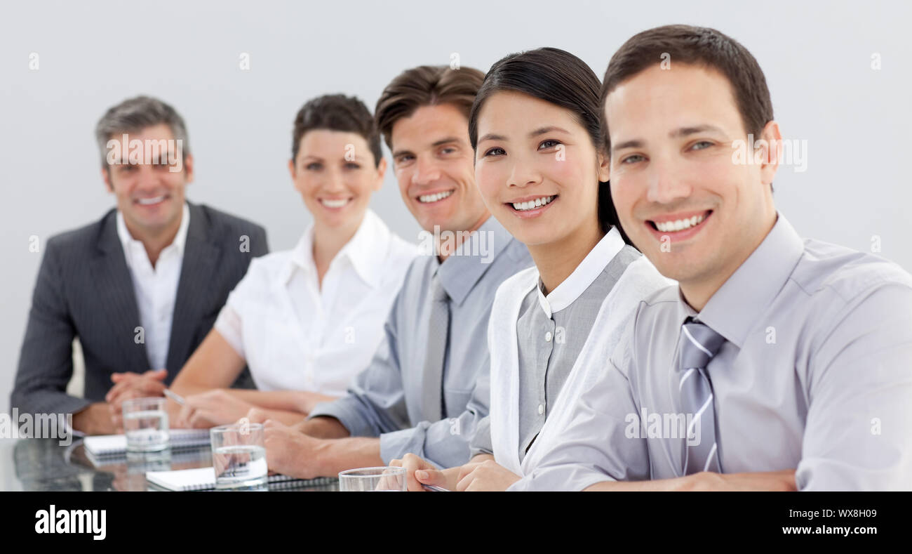 Business group showing diversity in a meeting looking at the camera ...
