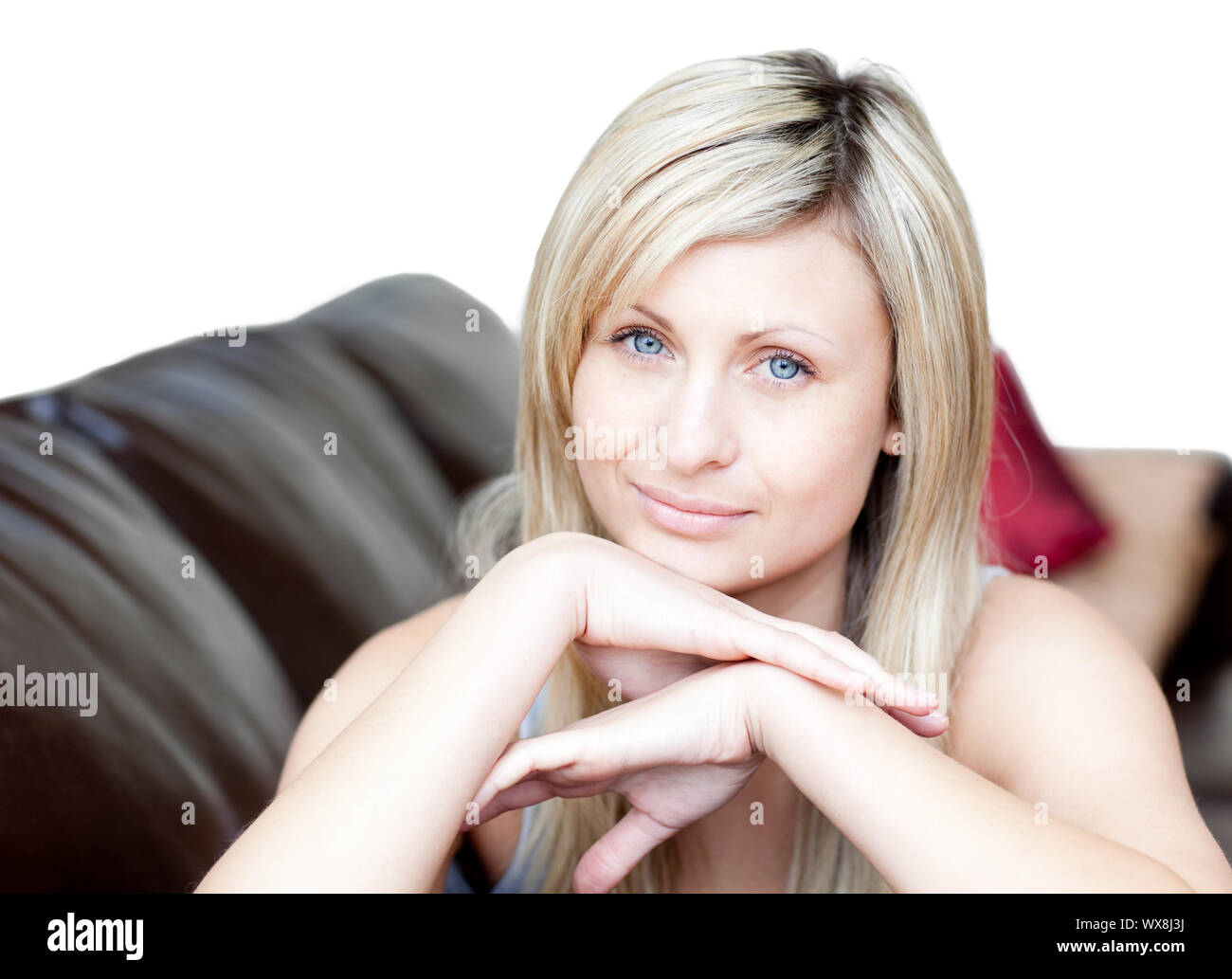 Portrait of a bright woman lying on the sofa against a white background ...