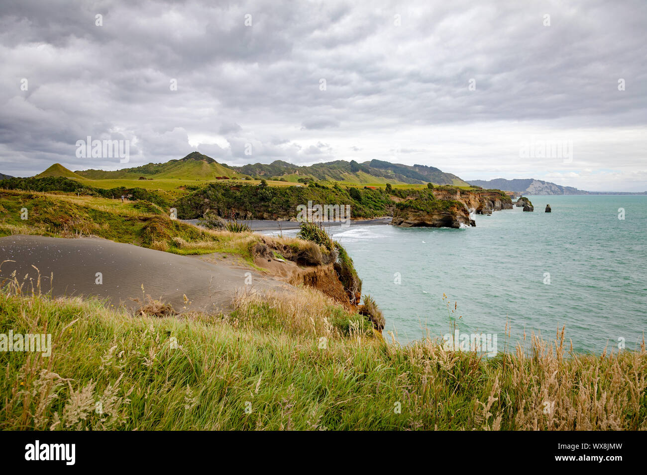 sea shore rocks and mount Taranaki, New Zealand Stock Photo
