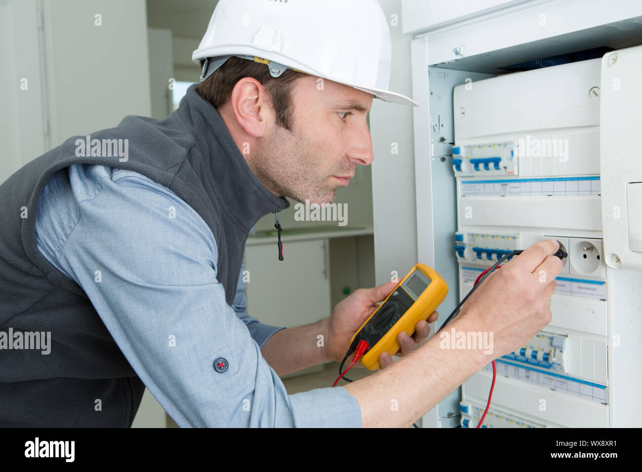 man working using multimeter electrician concept Stock Photo