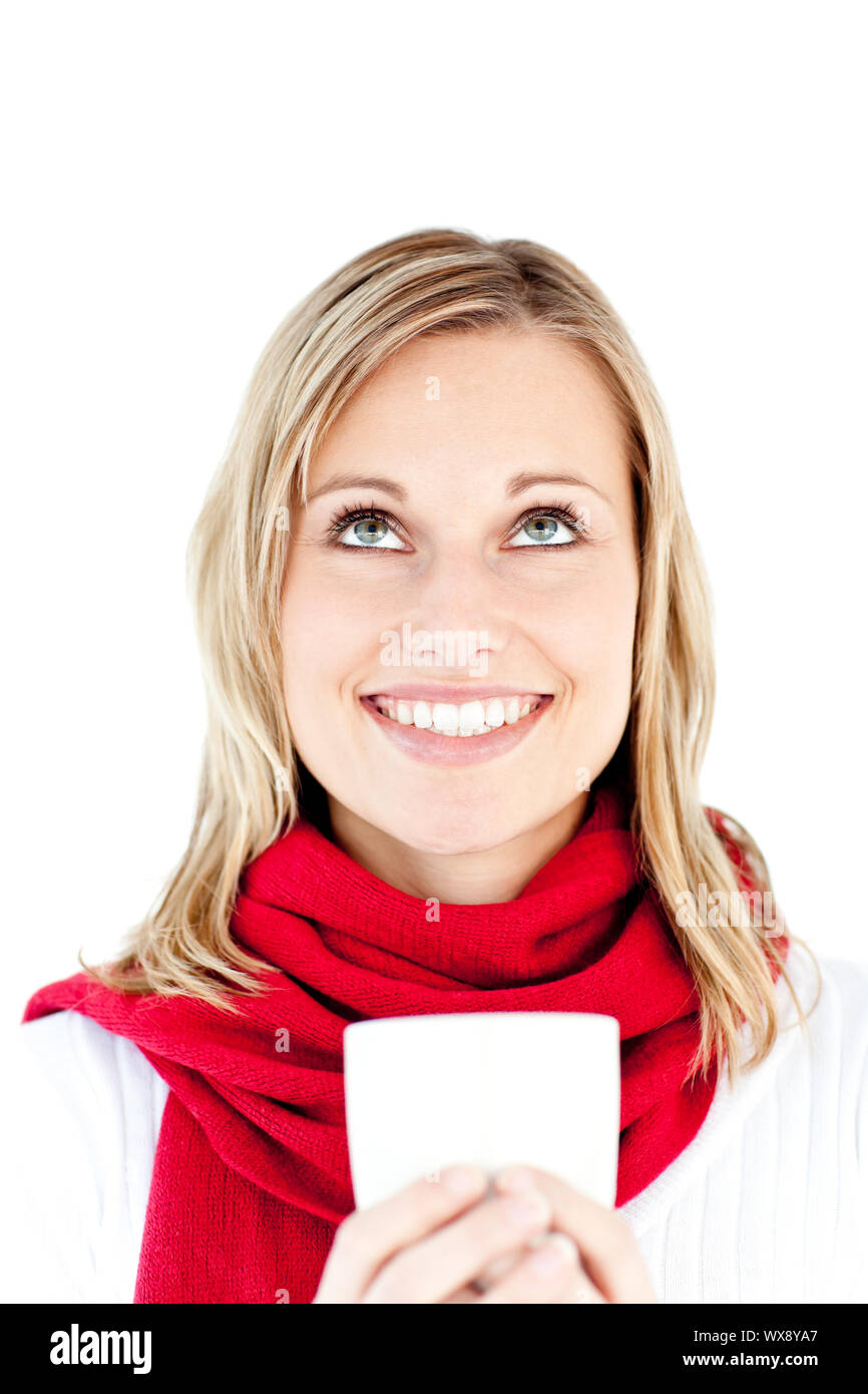 Blissful young woman holding a cup wearing a scarf against white background Stock Photo