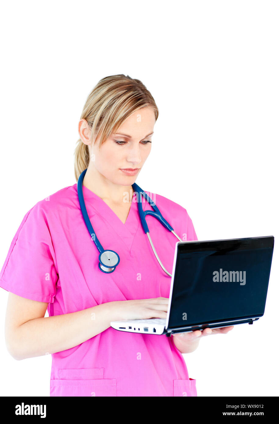 Concentrated female surgeon using a laptop against a white background Stock Photo