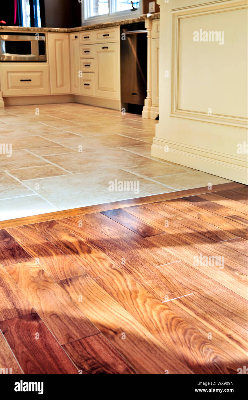 Hardwood and tile floor in residential home kitchen and dining room Stock  Photo - Alamy, image size:863x1390