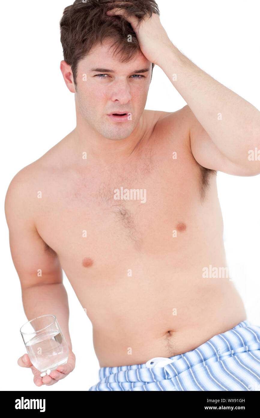 Tired Pyjamas tired man in pyjamas having a headache holding a glass of water against ...
