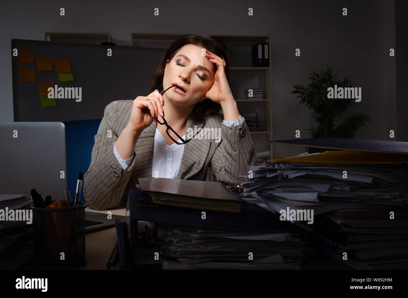 Female employee suffering from excessive work Stock Photo - Alamy