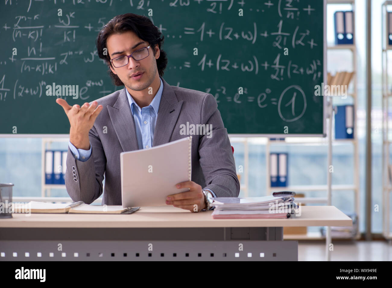 Young handsome math teacher in classroom Stock Photo