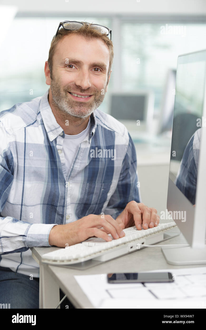 man is typing keyboard of the computer in the workplace Stock Photo - Alamy