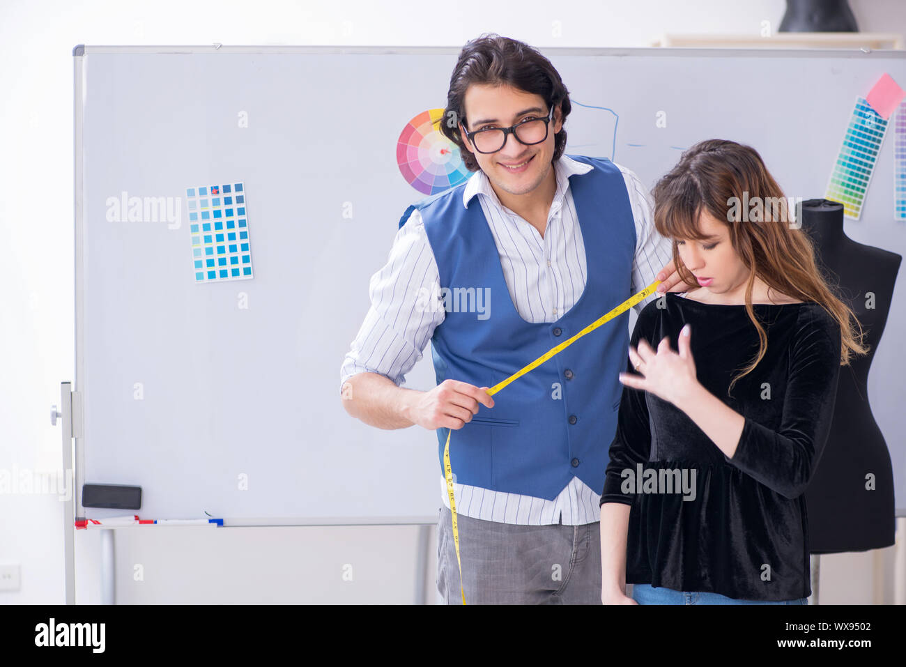 Professional male tailor taking measurements for blouse Stock Photo - Alamy