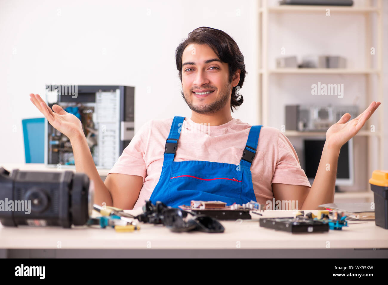 Young male contractor repairing computer Stock Photo