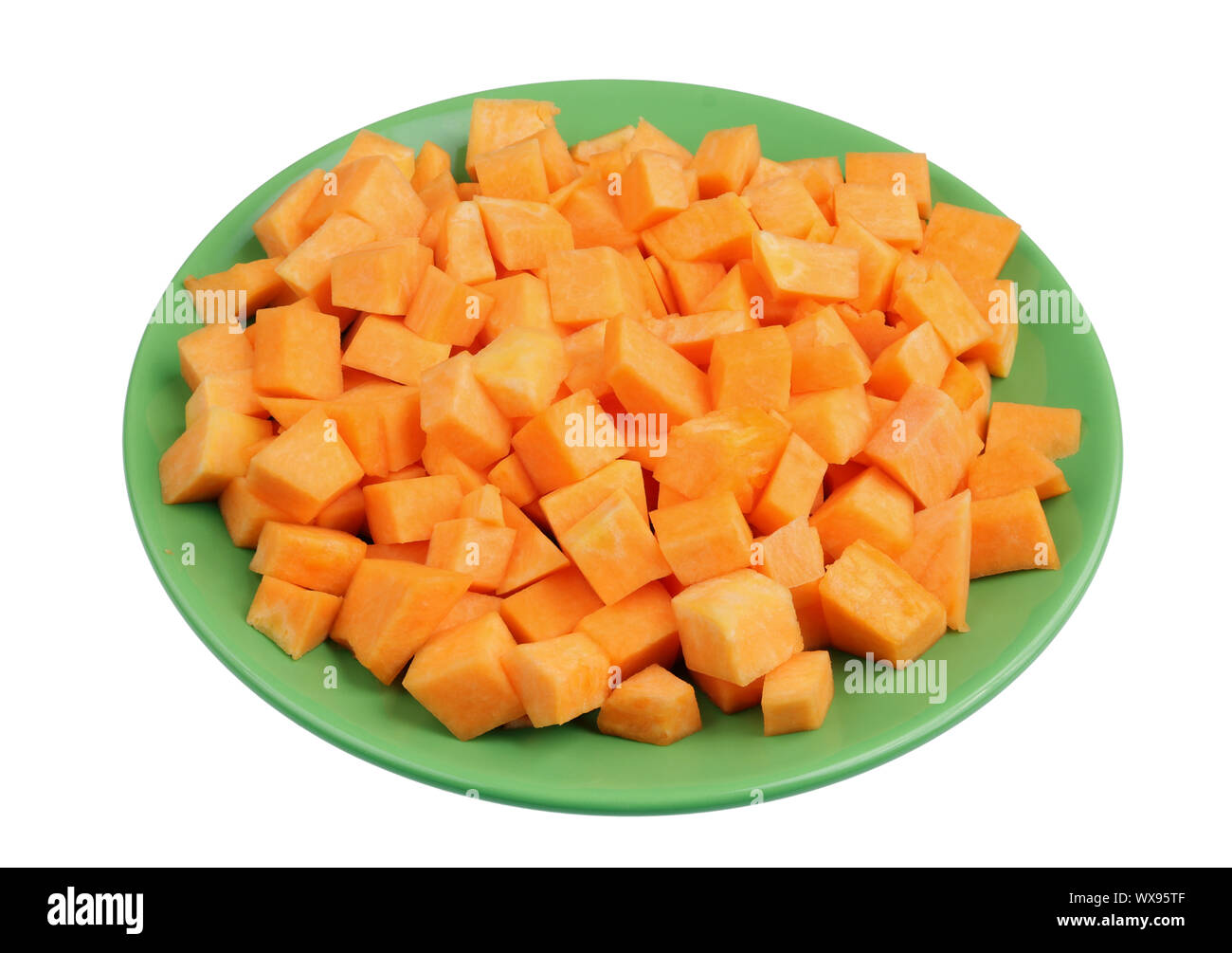 Slices of sweet orange pumpkin on a green plate isolated Stock Photo