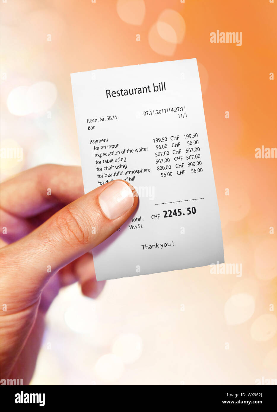 Restaurant bill for a large sum of money on hand Stock Photo