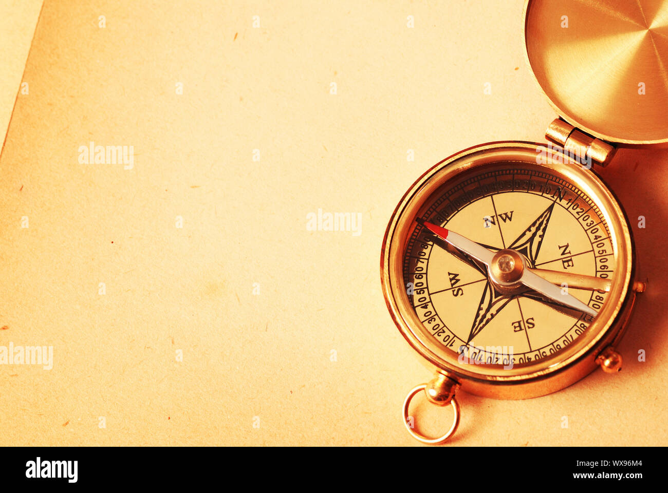 Antique brass compass over old map background Stock Photo - Alamy
