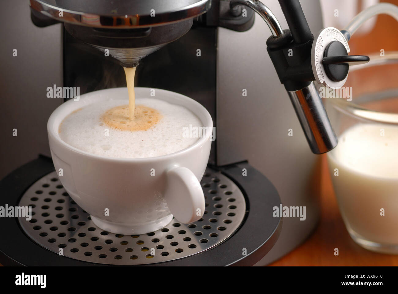 Making cappuccino with coffee machine 