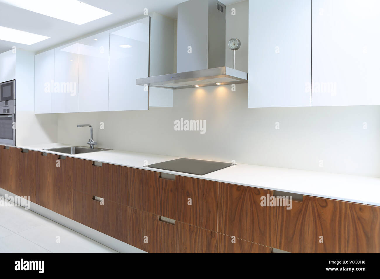 Actual modern kitchen in white and walnut wood interior house Stock ...