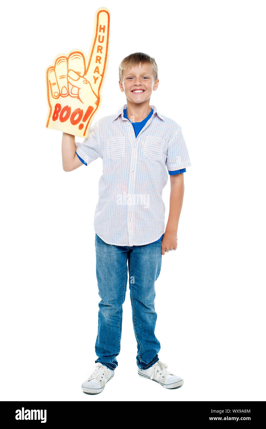 Full length portrait of a stylish young boy wearing a large foam hand. Boo and hurray! Stock Photo