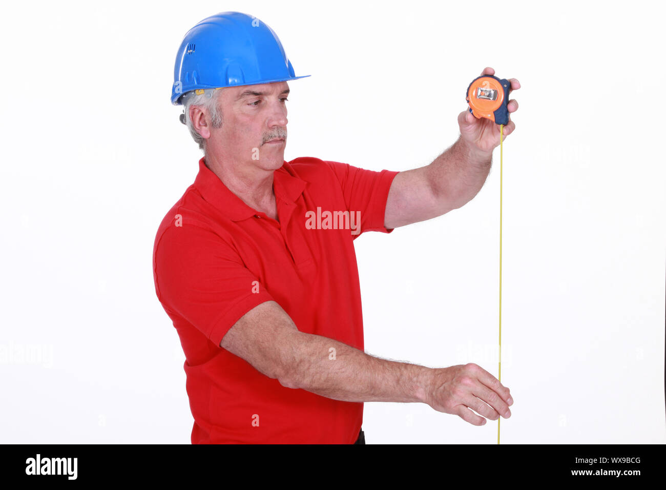 Tradesman using a measuring tape Stock Photo