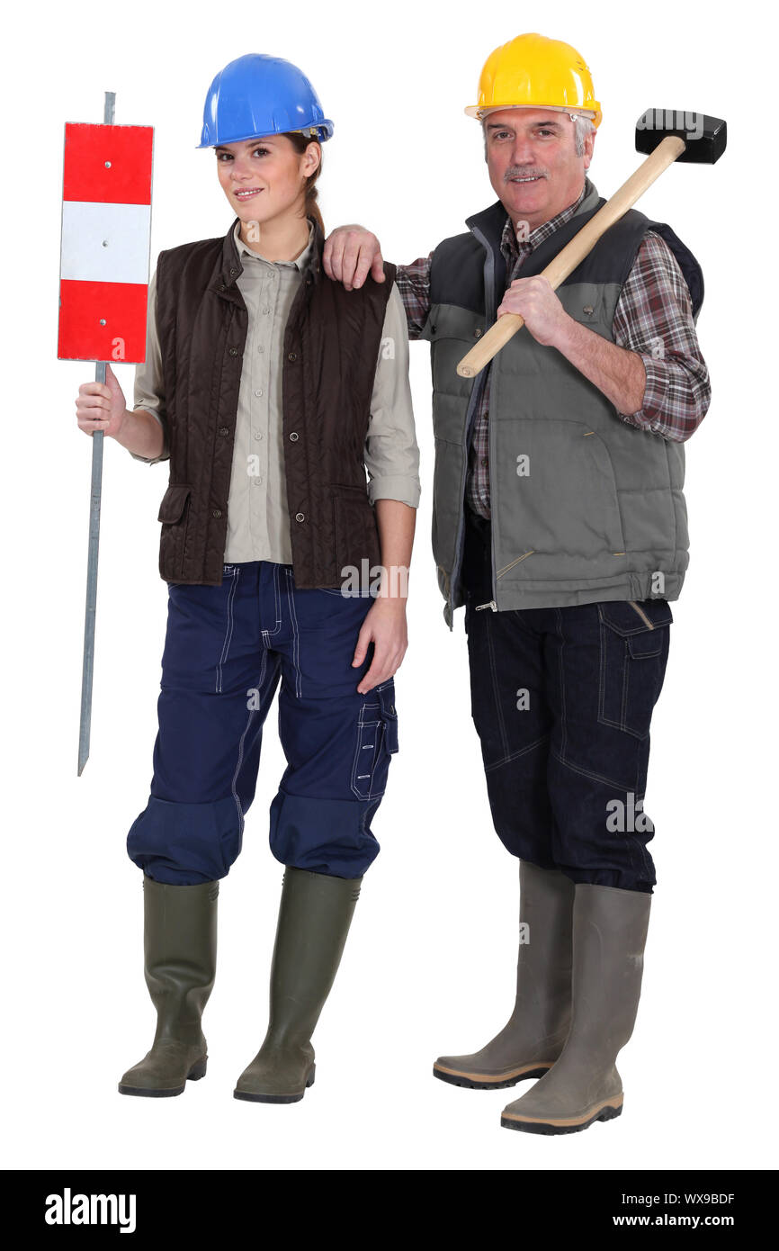 craftsman and young apprentice posing together Stock Photo
