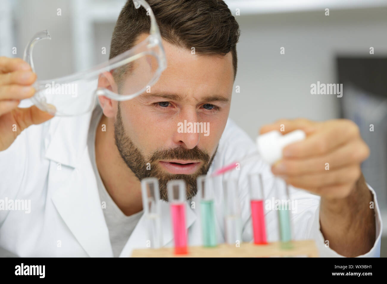 scientist holding an eppendorf tube and pipette Stock Photo
