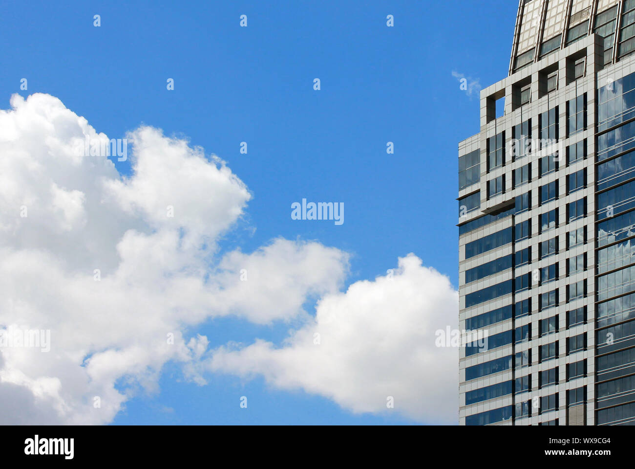 Cloudy sky reflected in the glass wall of a building Stock Photo - Alamy