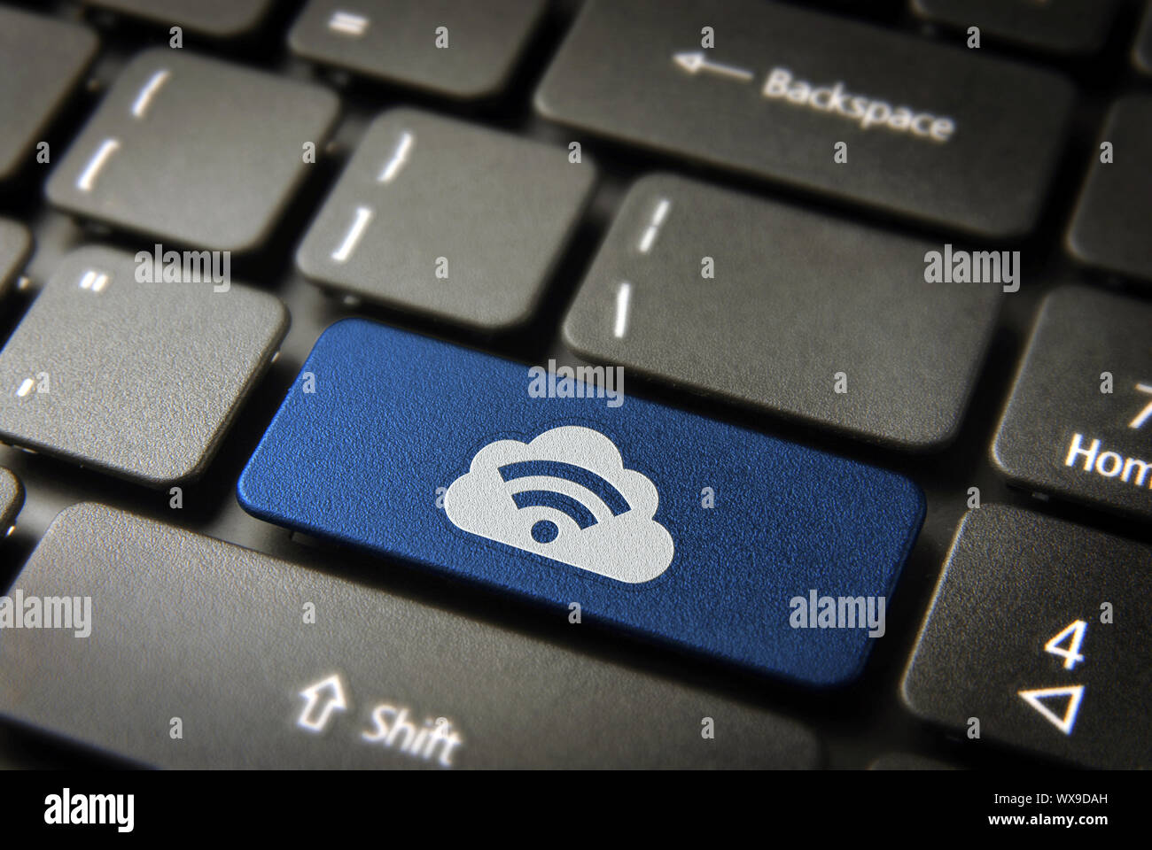 Blue technology key with RSS symbol and cloud computing icon on laptop keyboard. Included clipping path, so you can easily edit it. Stock Photo