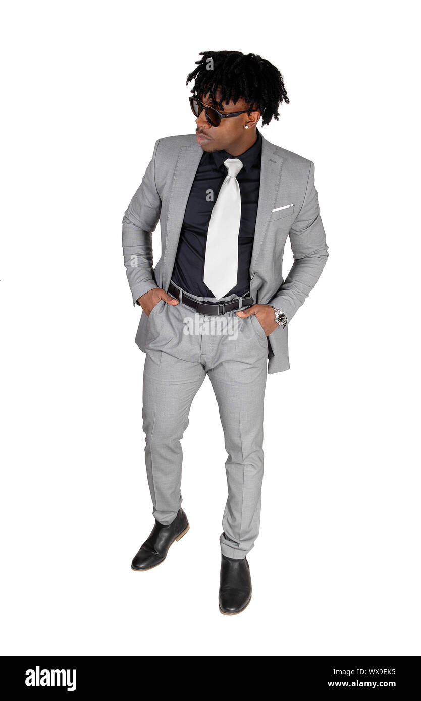 A black young man standing in a gray suit and sunglasses Stock Photo