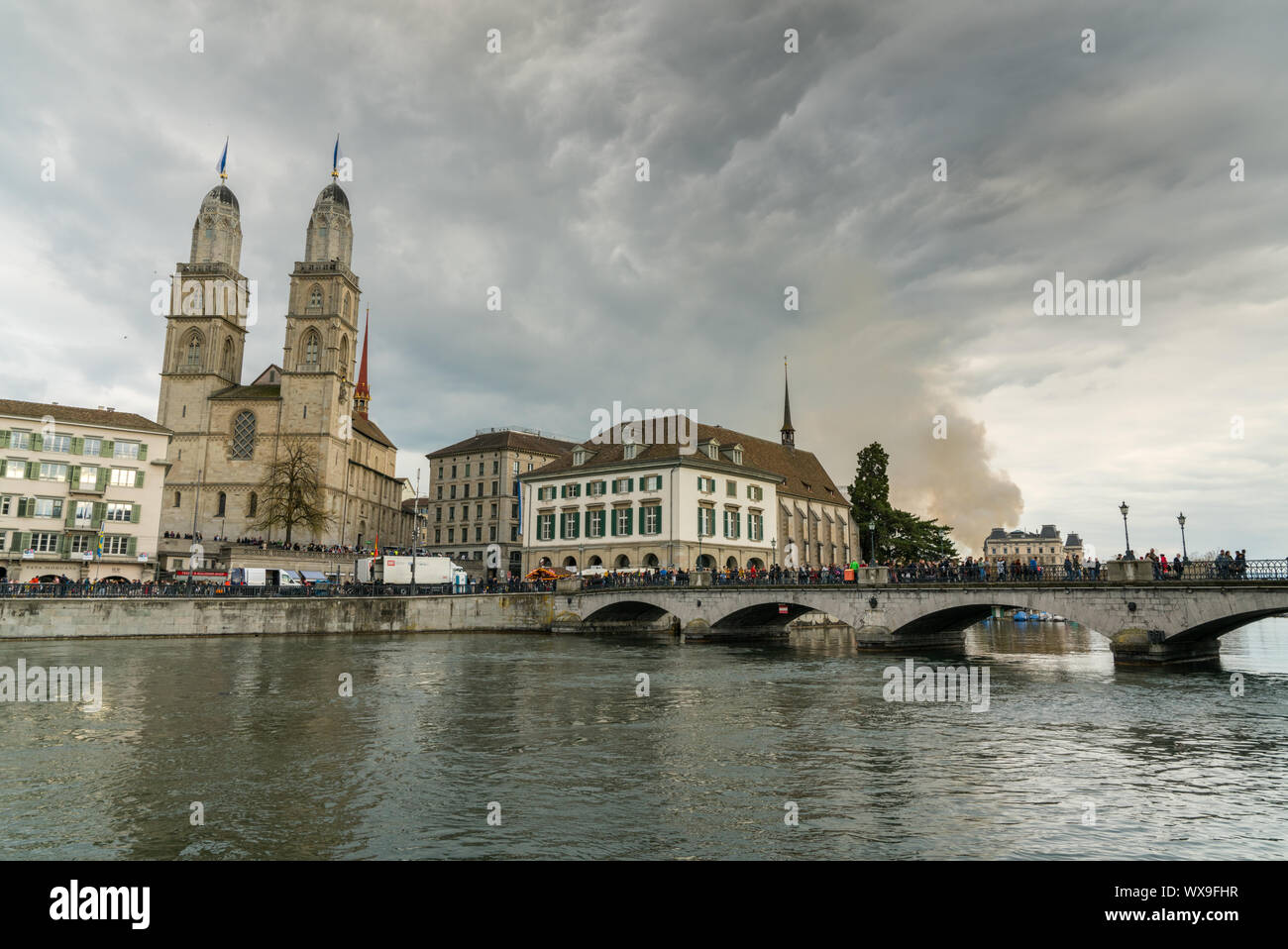 Zurich, ZH / Switzerland - April 8, 2019: Zurich cityscape with many people crossing the river Limma Stock Photo