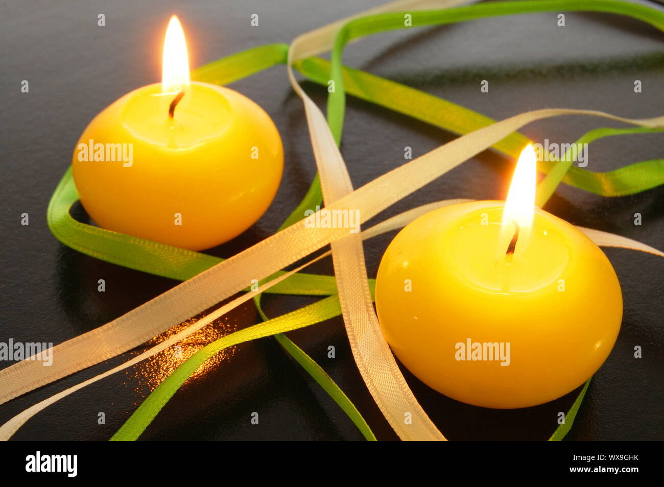 yellow candles showing spa or welllness concept Stock Photo Alamy