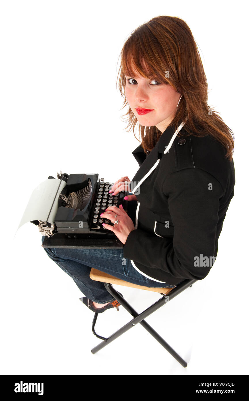 Girl with old black typewriter in funny perspective Stock Photo