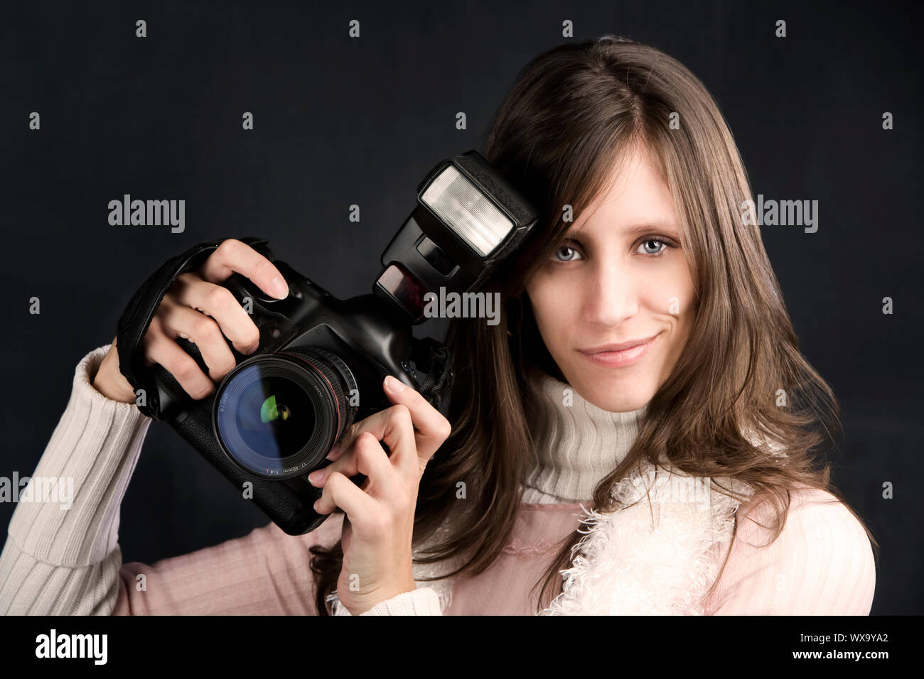 Pretty photographer with a professional camera and flash Stock Photo ...