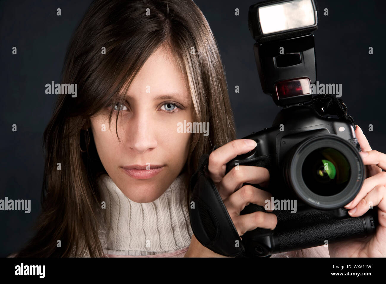 Pretty photographer with a professional camera and flash Stock Photo ...