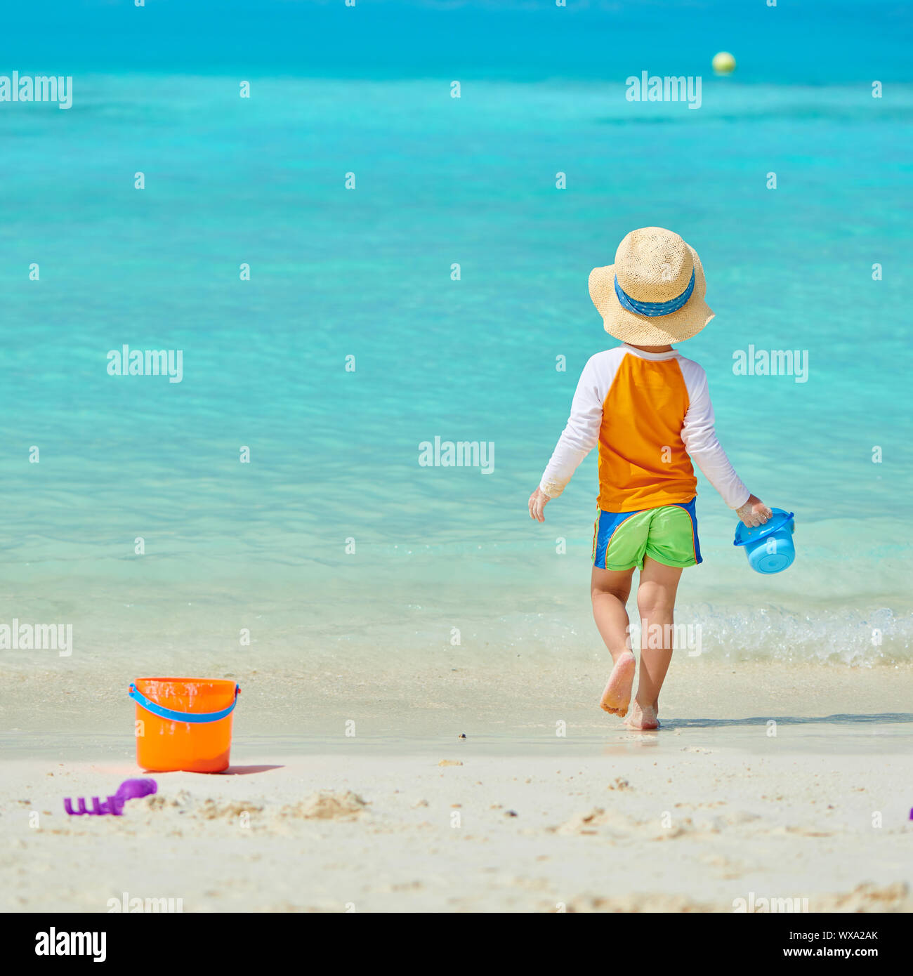 Three year old toddler playing on beach stock photo alamy