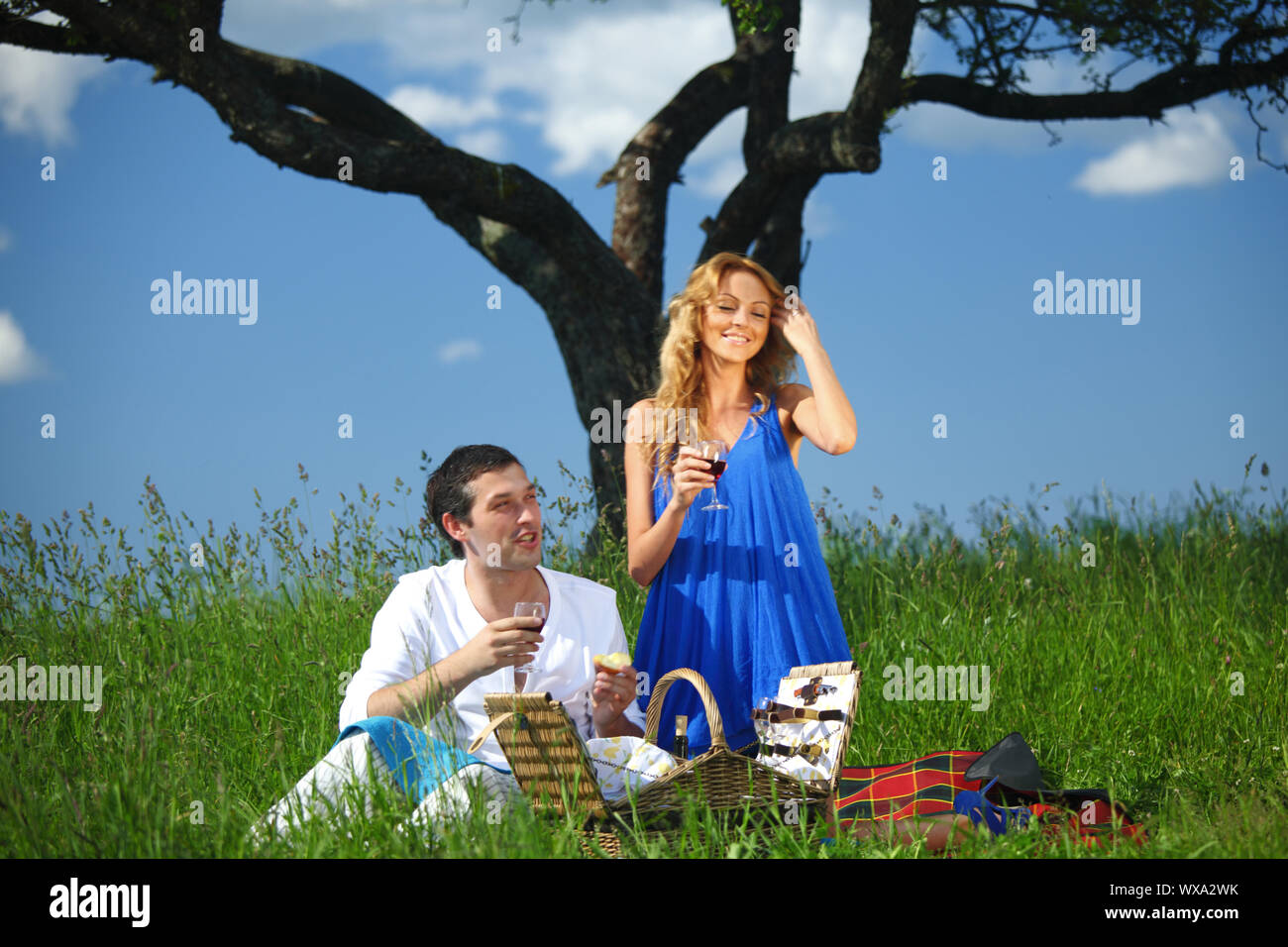 man and woman on picnic in green grass Stock Photo - Alamy