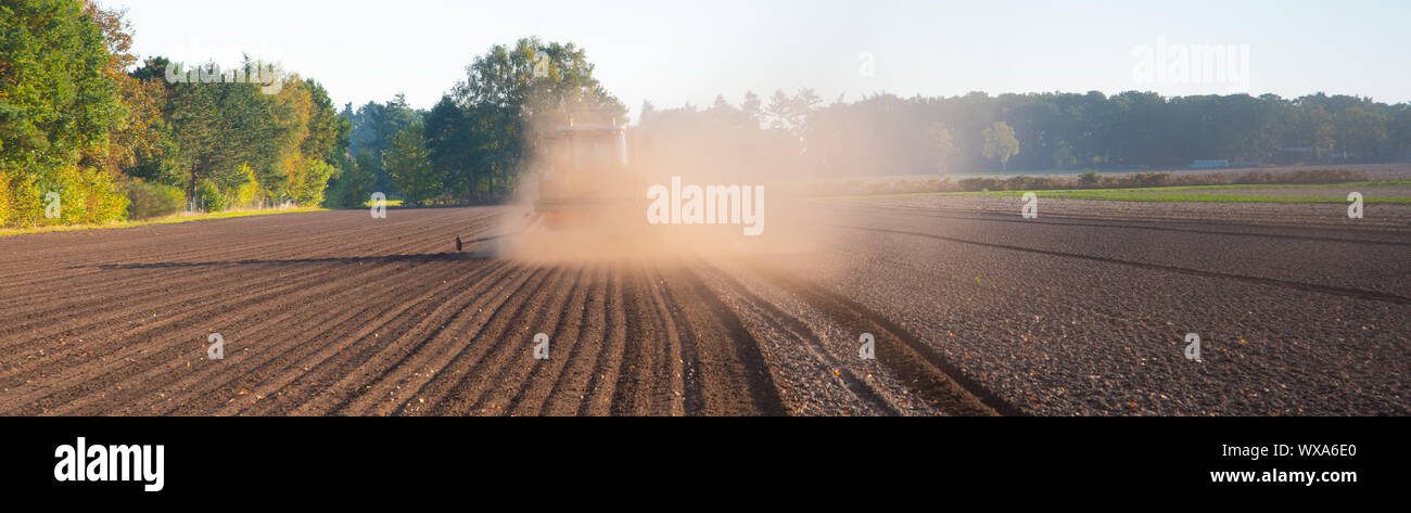 Field work with the tractor on the field Stock Photo - Alamy