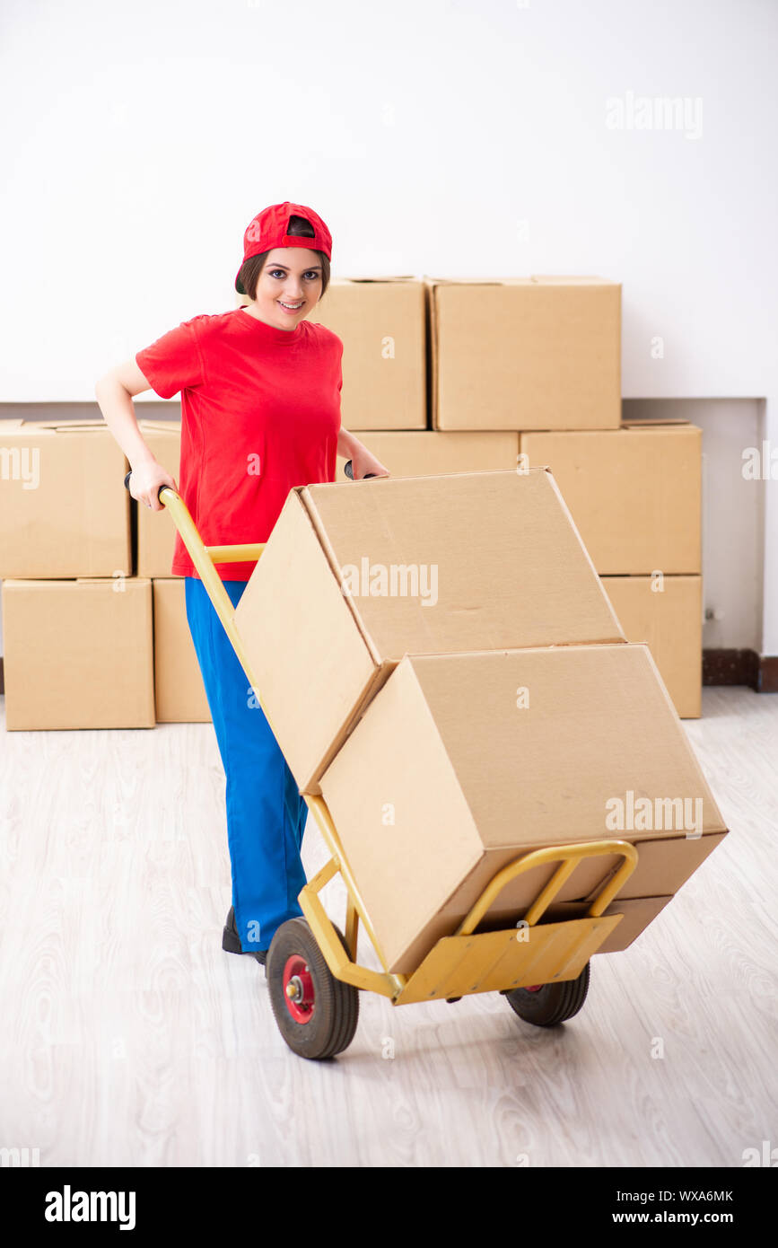 Young female professional mover doing home relocation Stock Photo