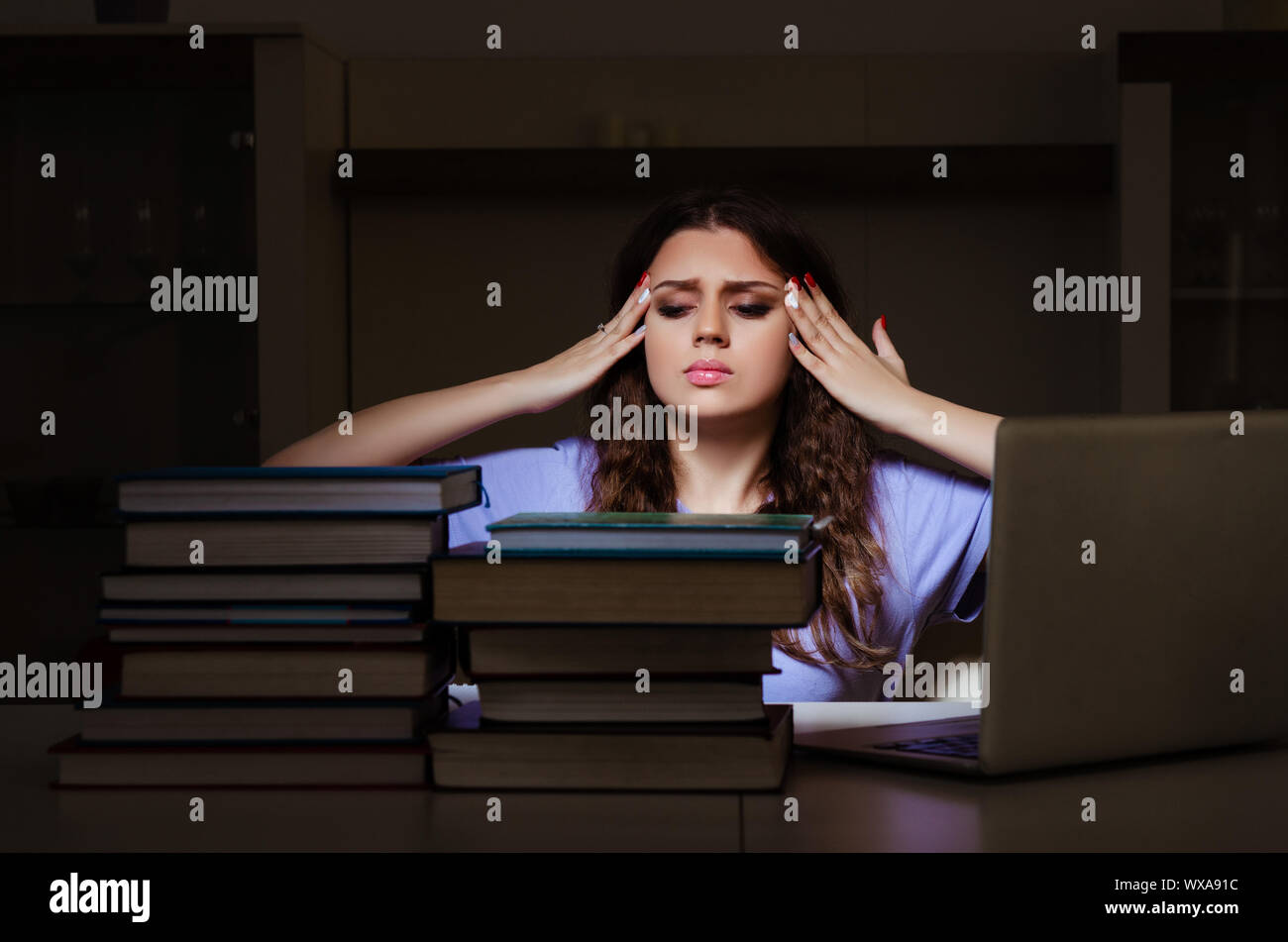 Young female student preparing for exams late at home Stock Photo - Alamy