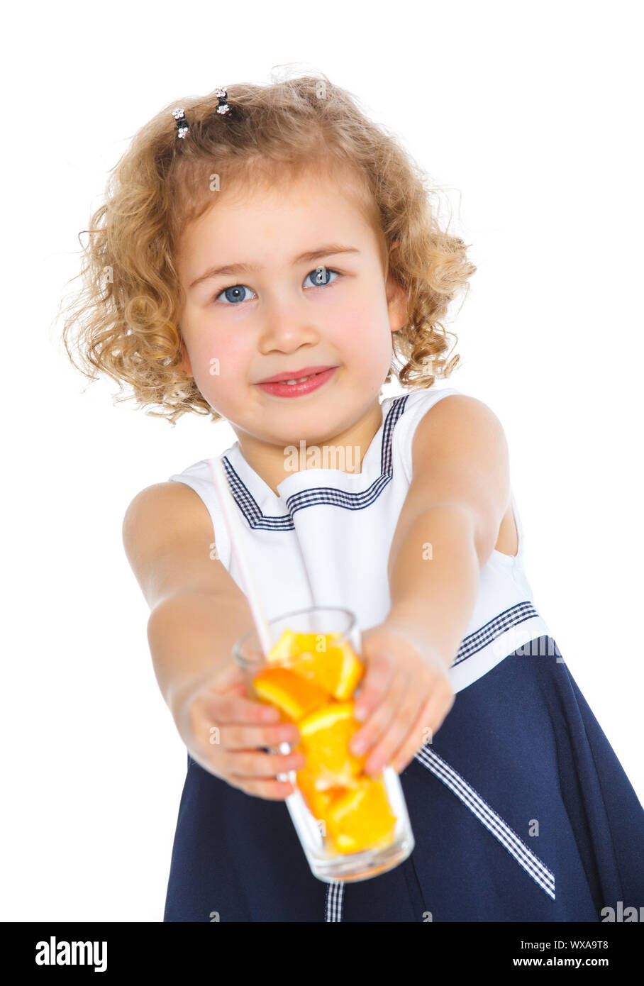 Portrait of happy little girl drinking orange juice. Isolated over ...