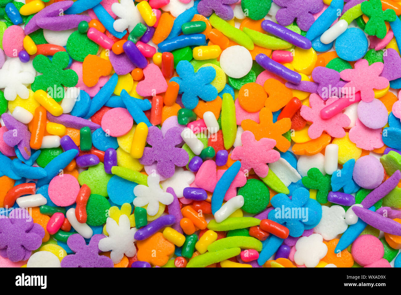 Mixed Candy Cookie and Cupcake Sprinkles Background. Stock Photo