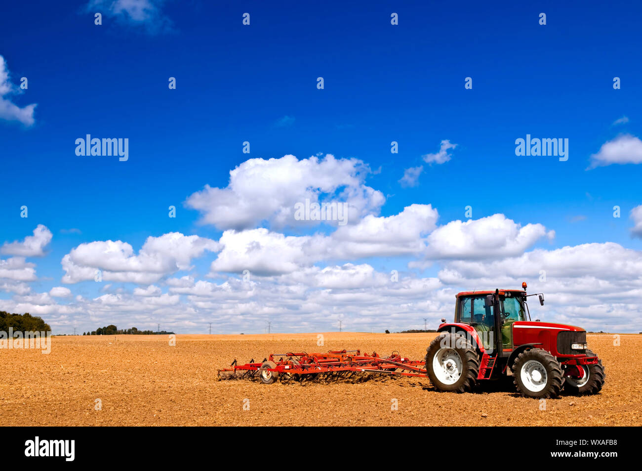 Small scale farming with tractor and plow in field Stock Photo Alamy