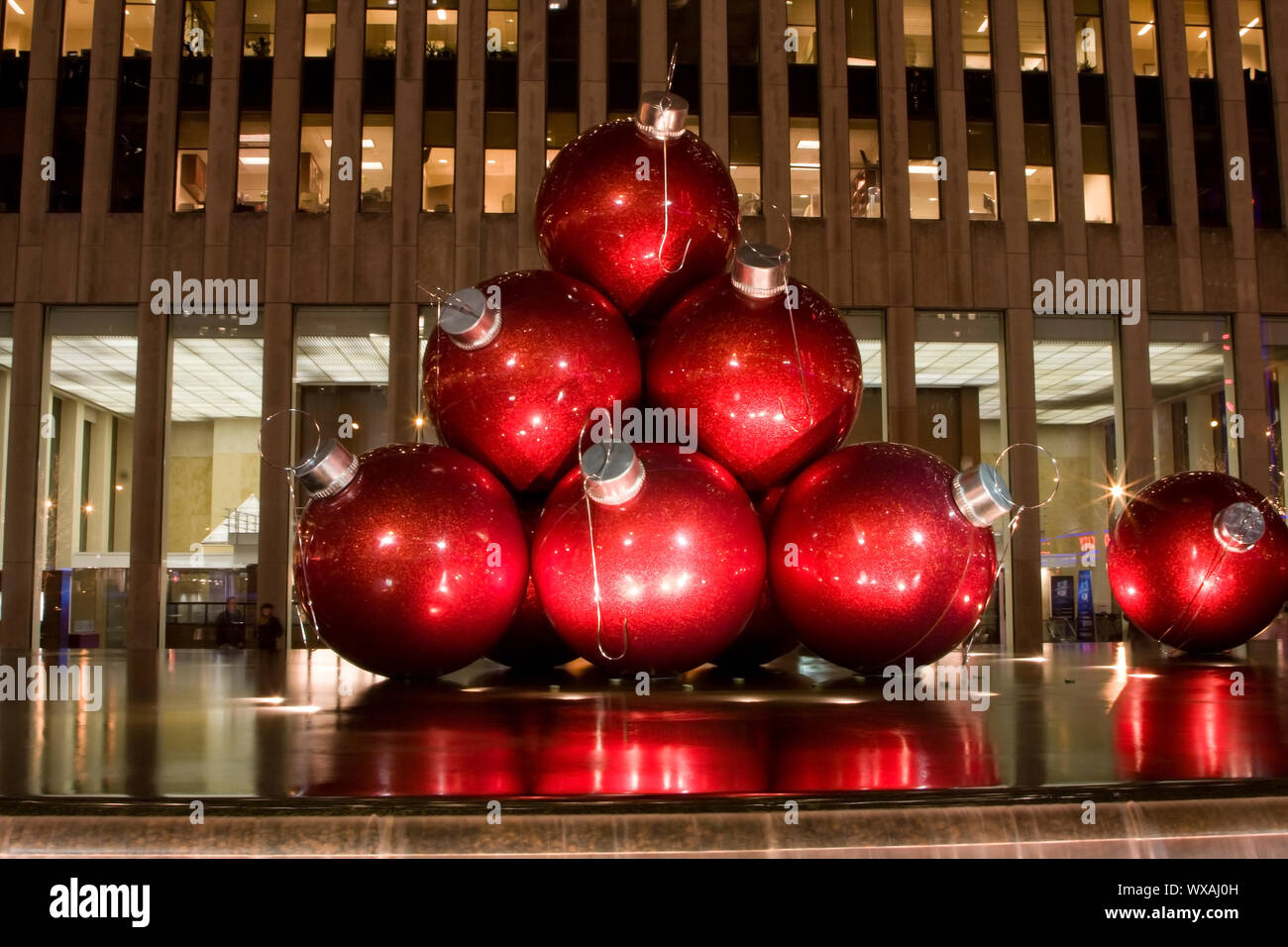 Big red balls as ornaments for the Christmas tree as an art exhibit on ...